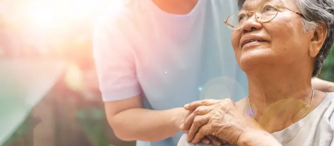 Caregiver, carer hand holding elder hand in hospice care. Philanthropy kindness to disabled concept.